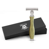 A metallic gold double edge safety razor with a branded black box packaging.