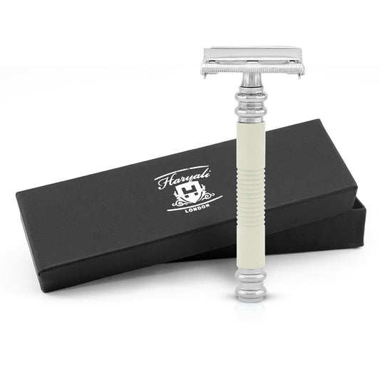 A safety razor with an ivory-colored handle, displayed alongside its black packaging box with the Haryali London logo.