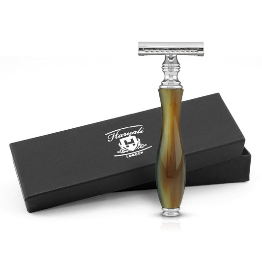 A safety razor with a brown and black buffalo horn imitation handle, displayed alongside its black box packaging with the Haryali London logo.