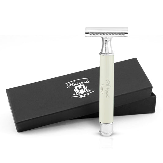 A safety razor with an ivory-colored handle, branded Haryali London, displayed alongside its black packaging box with the brand name and logo.