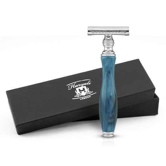 Blue-handled razor with silver blade and Haryali London packaging on a white background