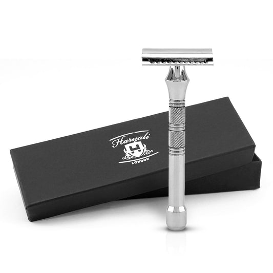 A stainless steel double edge safety razor with a silver color and a metallic grip, displayed alongside its black box packaging with the Haryali London logo.