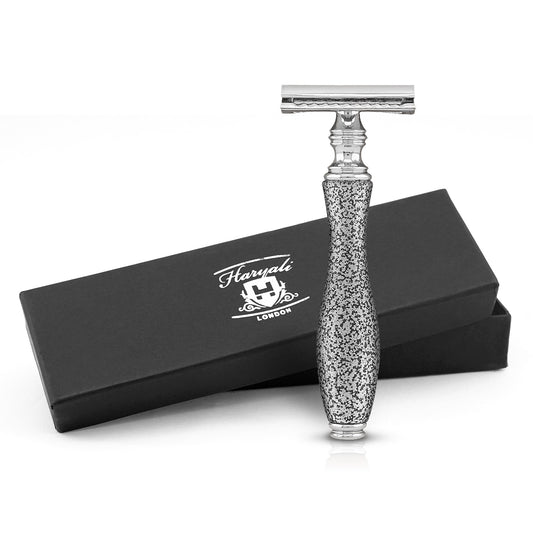 Silver safety razor with decorative handle on a white background