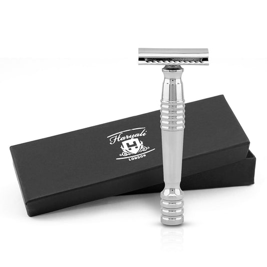 A stainless steel double edge safety razor with a heavy handle and silver in color. The razor is displayed alongside its black box packaging with Haryali London branding.