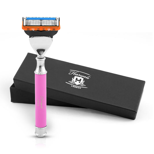 Shaving razor with pink handle and orange top on a white background